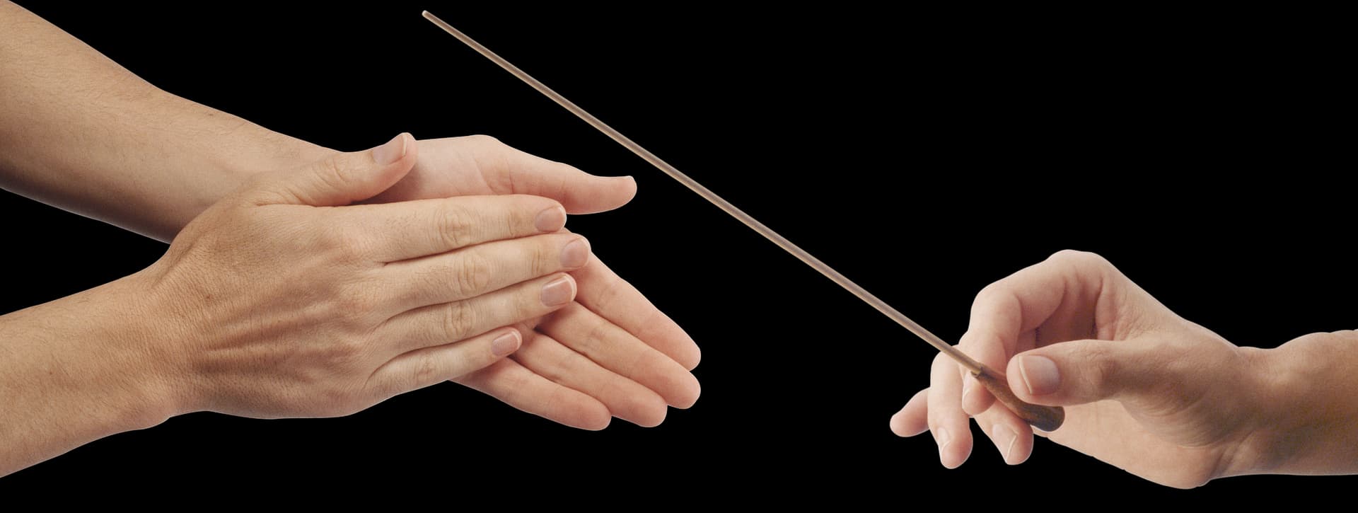 A pair of hands clapping on the left while another hand on the right holds a conductor's baton, as if directing an orchestra